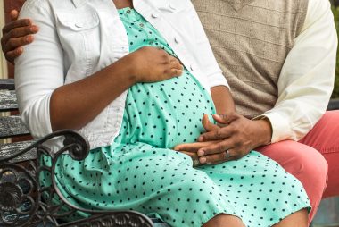 Pregnant African American couple.